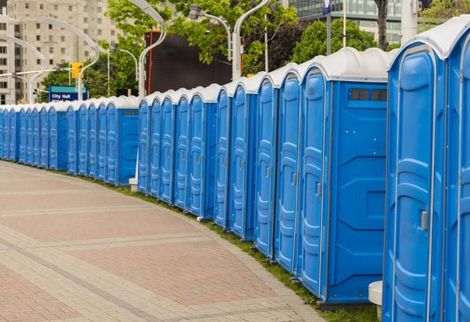 a row of portable restrooms set up for a large athletic event, allowing participants and spectators to easily take care of their needs in East Haddam